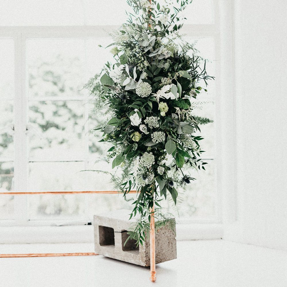 Wedding Ceremony Decor | Copper Arch with White Flowers and Foliage | Whitewashed Walls | Same Sex Wedding with Industrial Styling at Wimborne House | Marmelo Photography