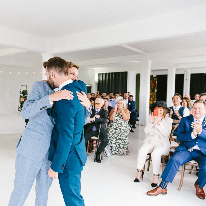 Wedding Ceremony | Just Married | Festoon Lights | Groom in Dark Petrol Blue Suit by Paul Smith | Groom in Light Blue Made To Measure Suit by Beggars Run | Same Sex Wedding with Industrial Styling at Wimborne House | Marmelo Photography