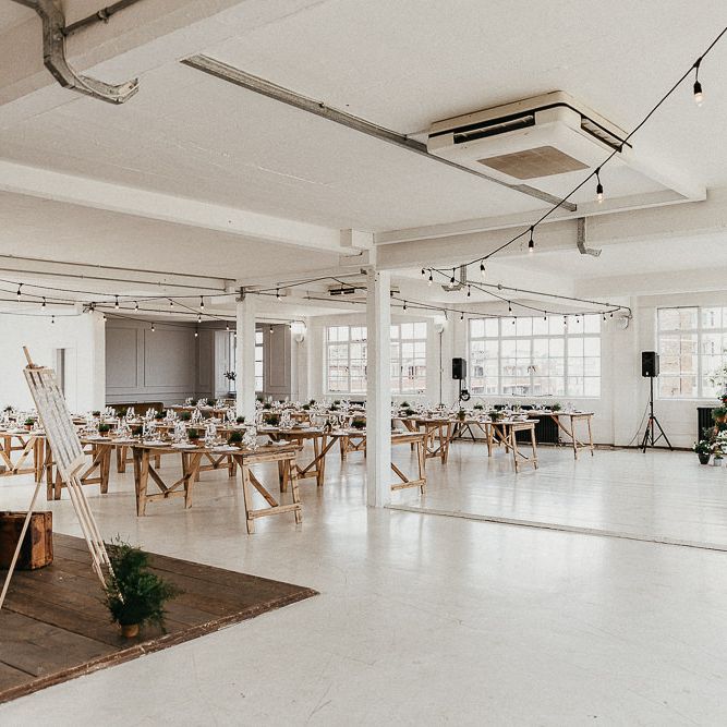 Wedding Reception Decor | Trestle Tables | Festoon Lights | Seating Plan | Windows | Whitewashed Walls | Industrial Ladder with Potted Plants | Same Sex Wedding with Industrial Styling at Wimborne House | Marmelo Photography