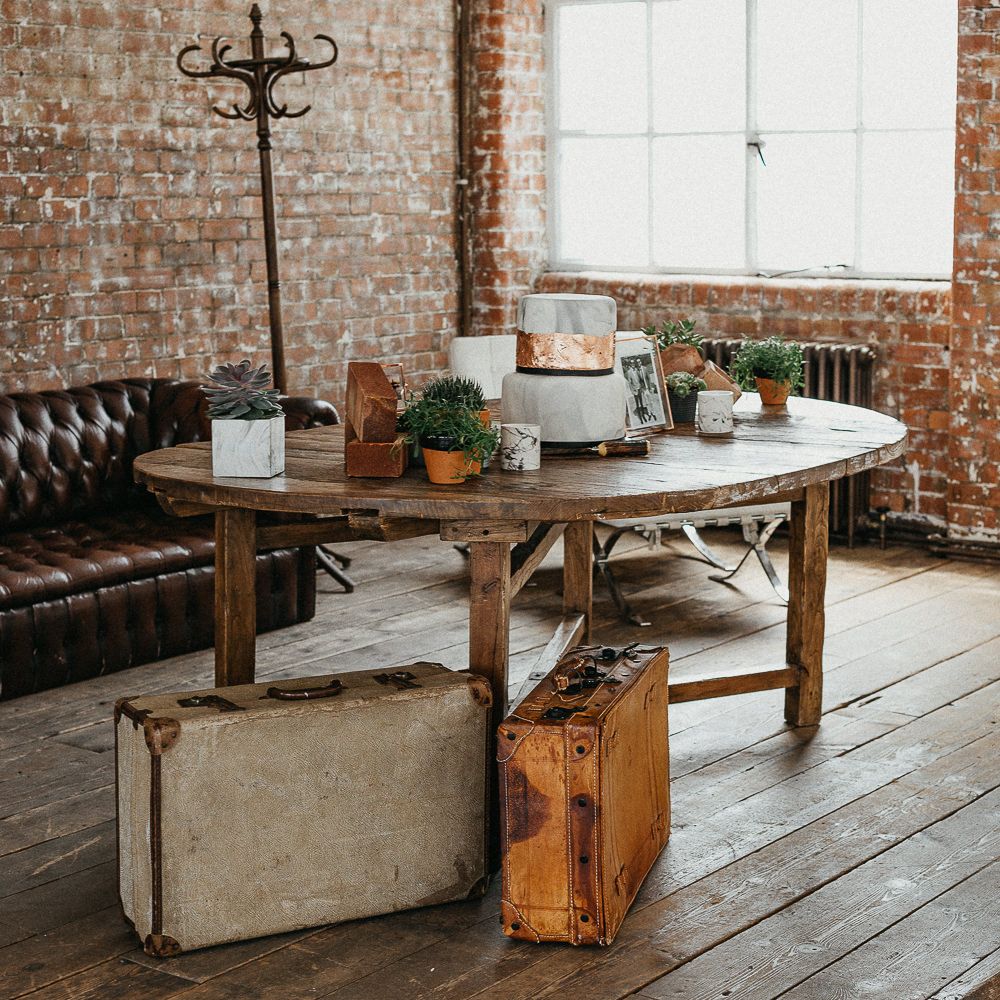 Wedding Reception Decor | Marble Wedding Cake with Copper Leaf | Potted Plants | Vintage Suitcases | Coat Stand | Same Sex Wedding with Industrial Styling at Wimborne House | Marmelo Photography