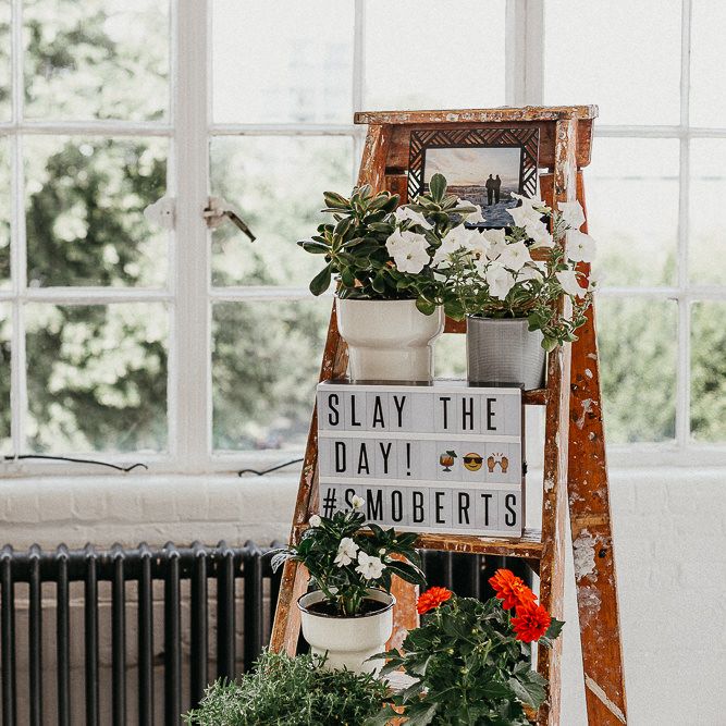 Wedding Reception Decor | Industrial Ladder with Potted Plants | Light Box | Large Warehouse Window | Same Sex Wedding with Industrial Styling at Wimborne House | Marmelo Photography