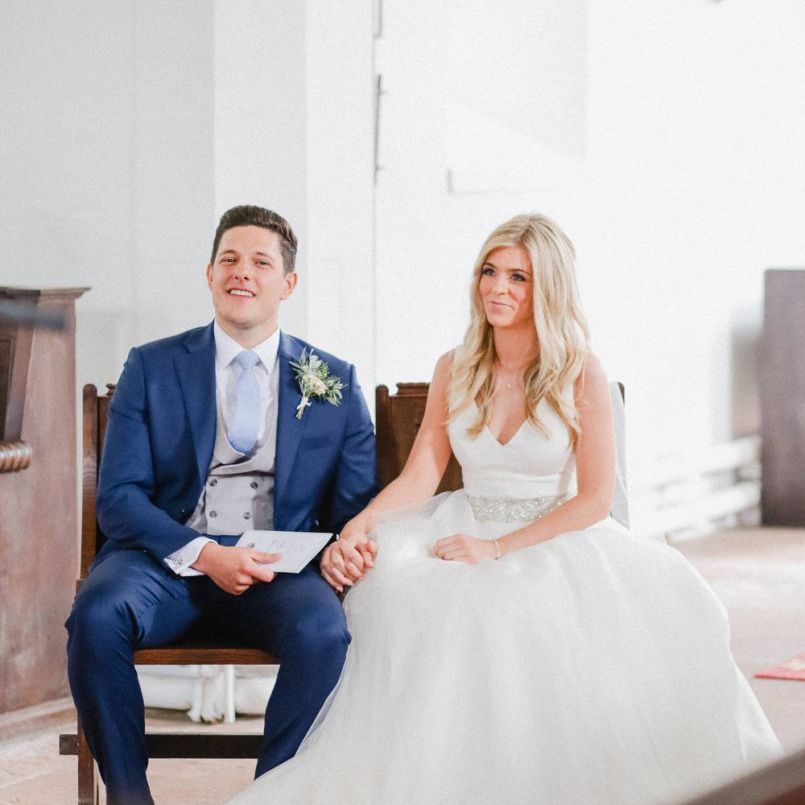 Bride and groom holding hands in the church wedding ceremony