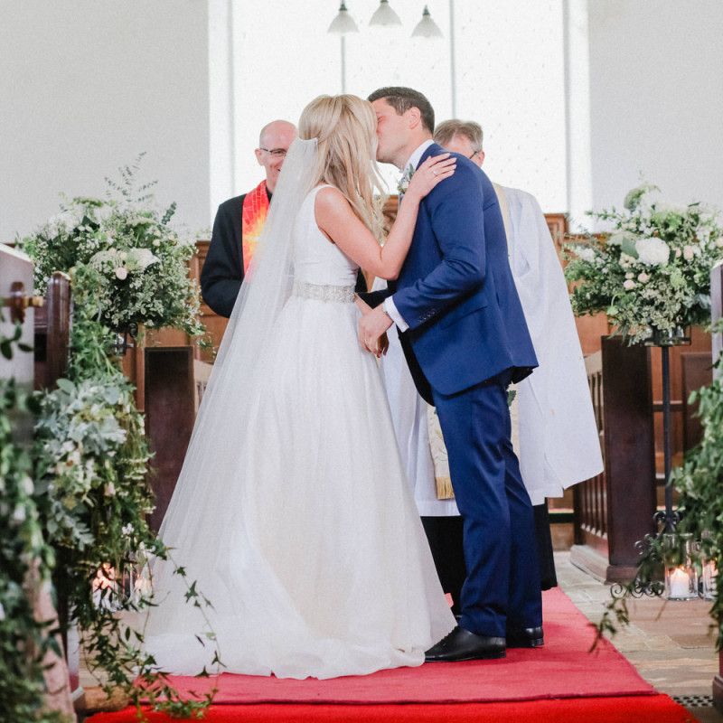 You may now kiss the bride moment at church wedding ceremony