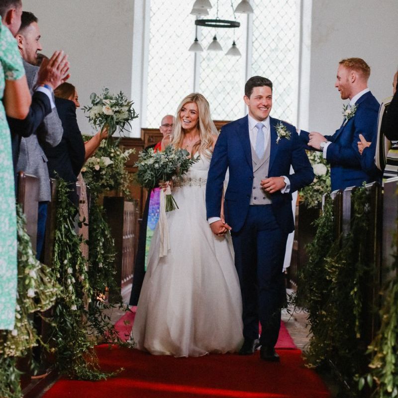 Bride and groom walking up the aisle as husband and wife
