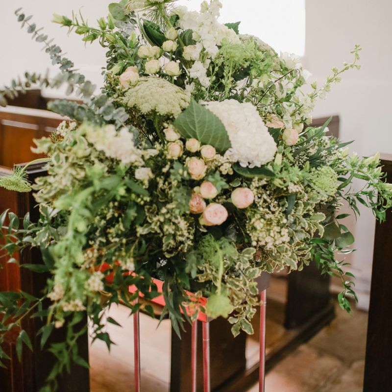 Green, white and pink church wedding flower arrangement