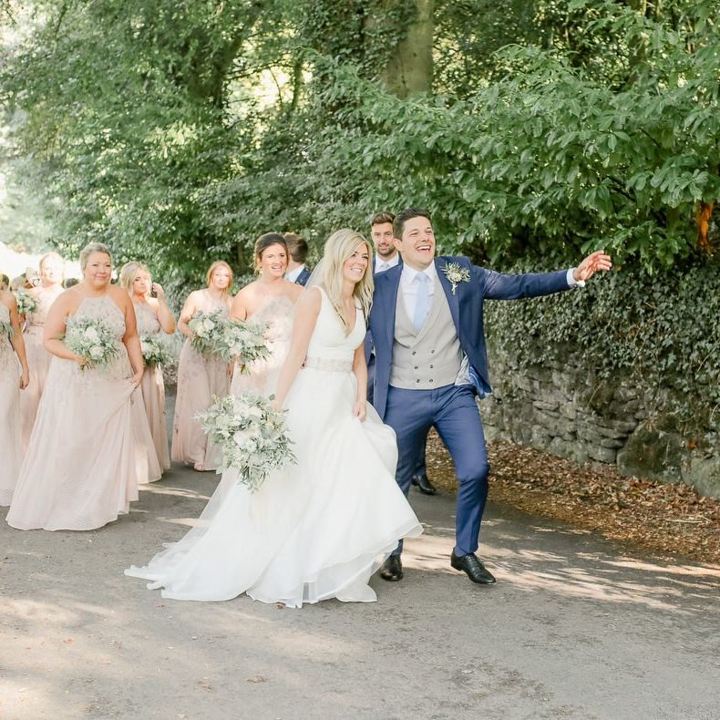 Wedding guests walking from the church to the Askham Hall  reception