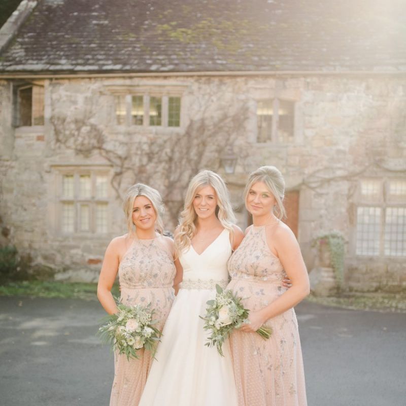 Bride in Sassi Holford wedding Dress and bridesmaids in halter neck dresses
