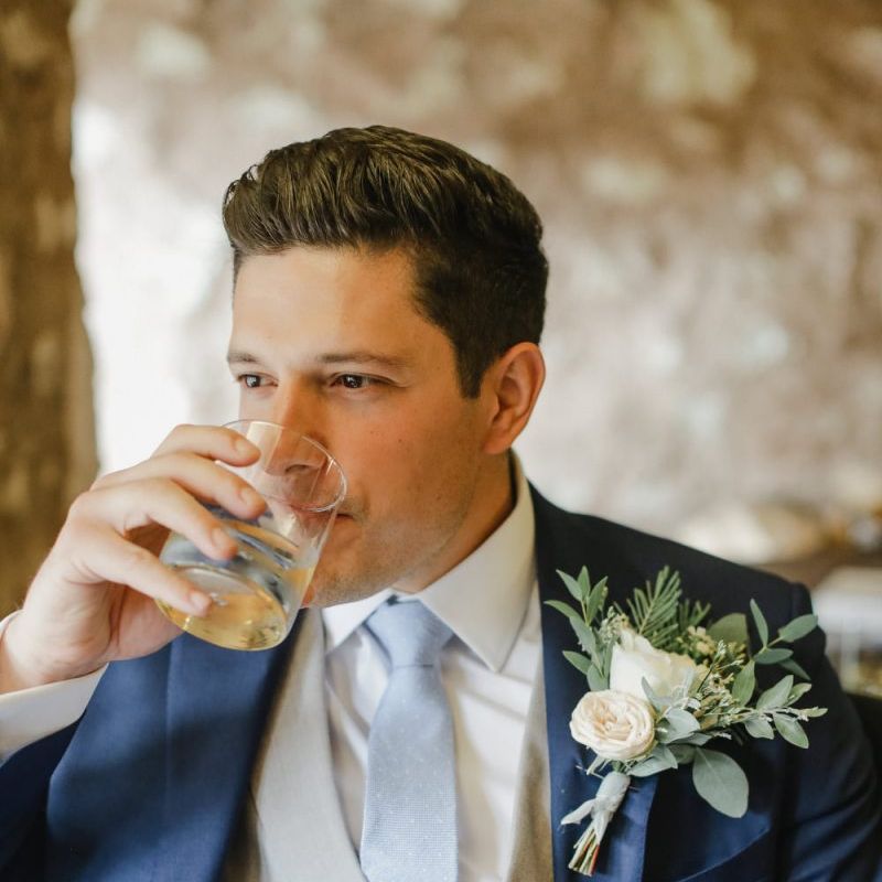 Groom in classic navy suit with grey horseshoe waistcoat
