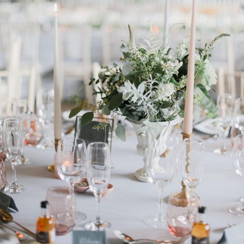Romantic table centrepiece decor with flowers and taper candles