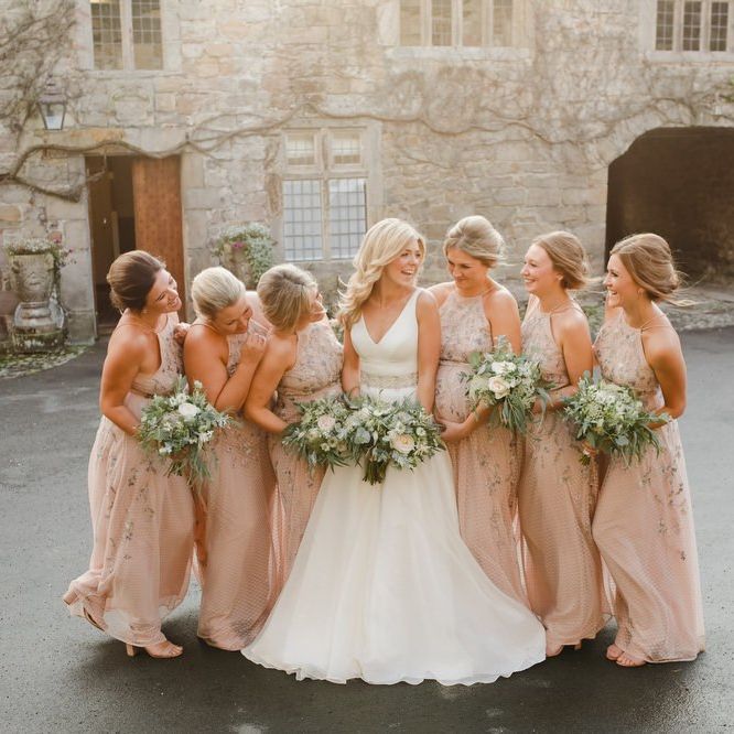 bridal party portrait at Askham Hall with bridesmaids in pink dresses
