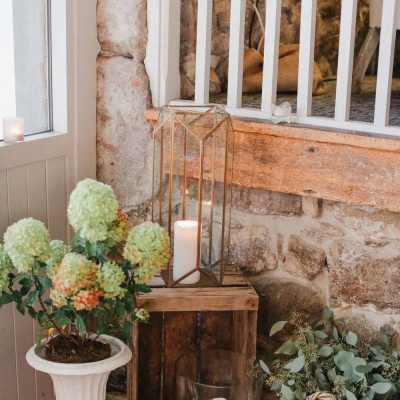 Flower pot, lantern and wooden crate wedding decor at Askham Hall