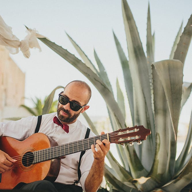 Outdoor Wedding Ceremony | Guitarist | Brightly Coloured Destination Wedding at Masseria Potenti Wedding Venue, Puglia, South Italy | Petar Jurica Photography | Marco Odorino Film