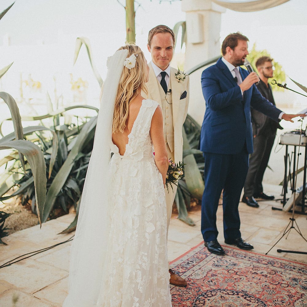 Outdoor Wedding Ceremony | Bride in Custom Clemence Halfpenny London Bridal Gown | Groom in Cream Three Piece Suit | Brightly Coloured Destination Wedding at Masseria Potenti Wedding Venue, Puglia, South Italy | Petar Jurica Photography | Marco Odorino Film