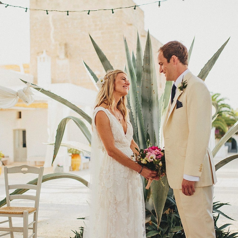 Outdoor Wedding Ceremony | Bride in Custom Clemence Halfpenny London Bridal Gown | Groom in Cream Three Piece Suit | Brightly Coloured Destination Wedding at Masseria Potenti Wedding Venue, Puglia, South Italy | Petar Jurica Photography | Marco Odorino Film