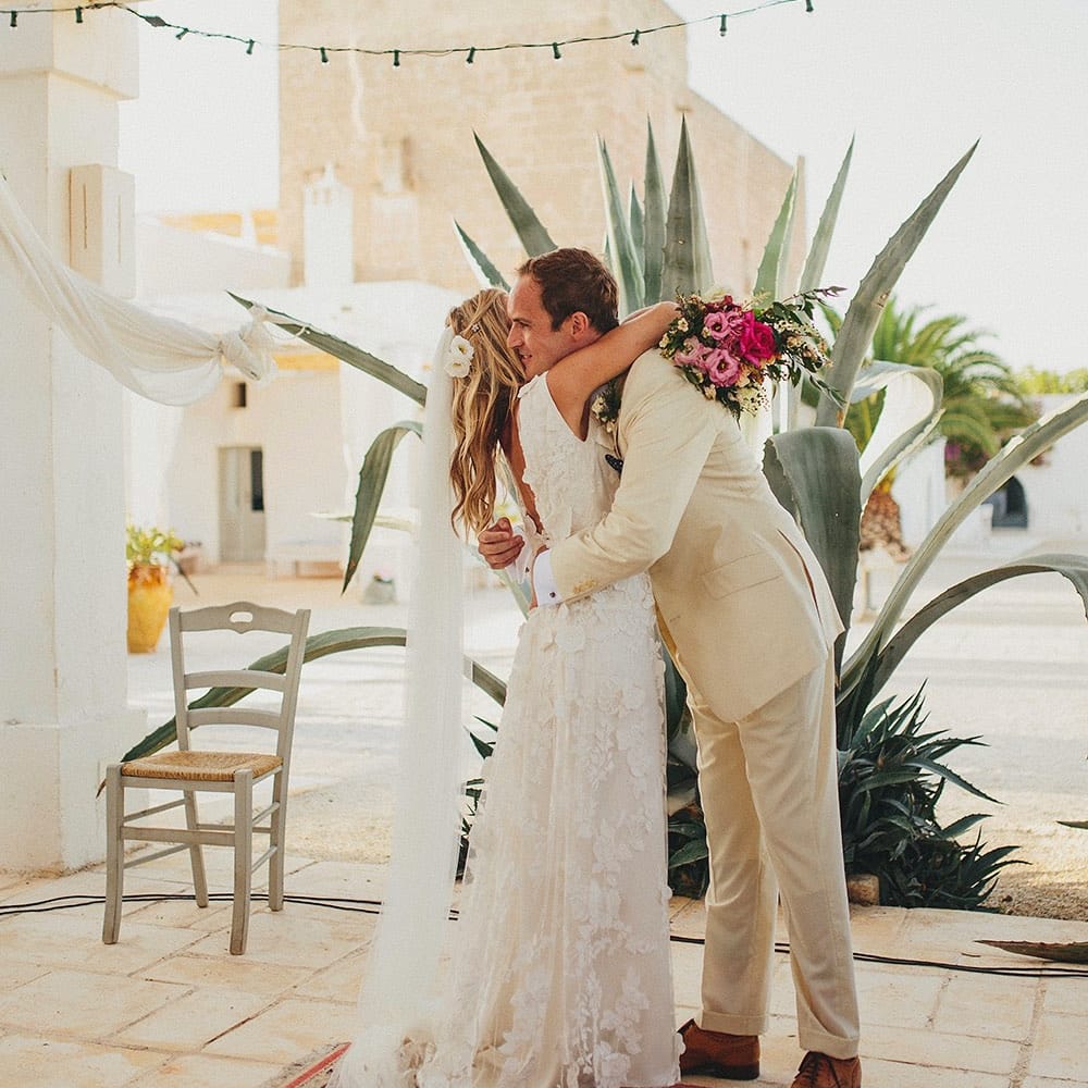 Outdoor Wedding Ceremony | Bride in Custom Clemence Halfpenny London Bridal Gown | Groom in Cream Three Piece Suit | Brightly Coloured Destination Wedding at Masseria Potenti Wedding Venue, Puglia, South Italy | Petar Jurica Photography | Marco Odorino Film