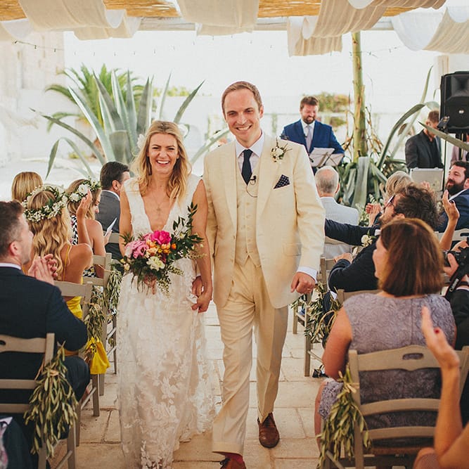 Outdoor Wedding Ceremony | Bride in Custom Clemence Halfpenny London Bridal Gown | Groom in Cream Three Piece Suit | Brightly Coloured Destination Wedding at Masseria Potenti Wedding Venue, Puglia, South Italy | Petar Jurica Photography | Marco Odorino Film