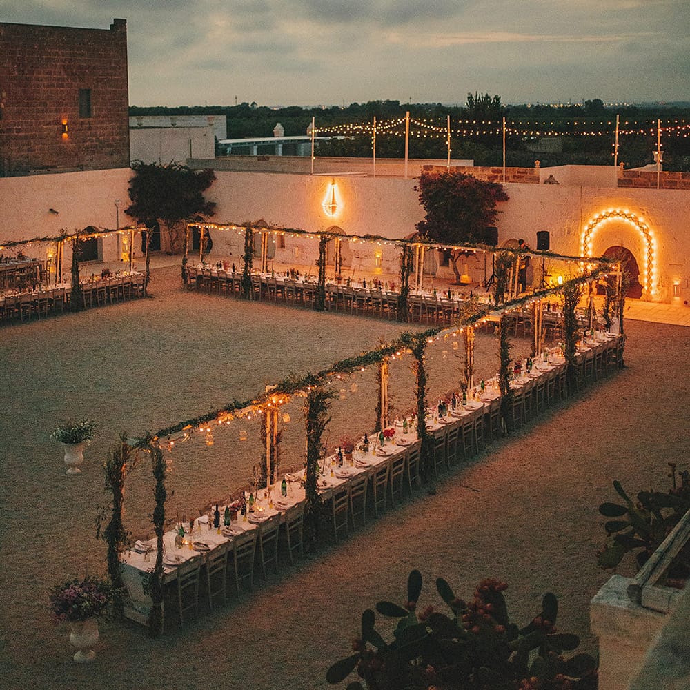 Outdoor Wedding Reception with Fairy Lights | Brightly Coloured Destination Wedding at Masseria Potenti Wedding Venue, Puglia, South Italy | Petar Jurica Photography | Marco Odorino Film