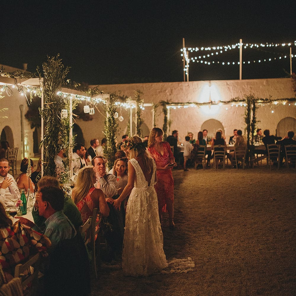 Outdoor Wedding Reception with Fairy Lights | Brightly Coloured Destination Wedding at Masseria Potenti Wedding Venue, Puglia, South Italy | Petar Jurica Photography | Marco Odorino Film