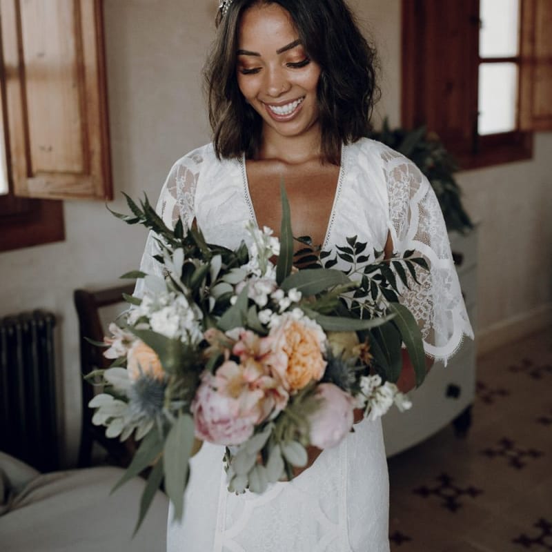 Boho bride in Grace Loves Lace wedding dress and Tilly Thomas Lux headband  holding her bouquet