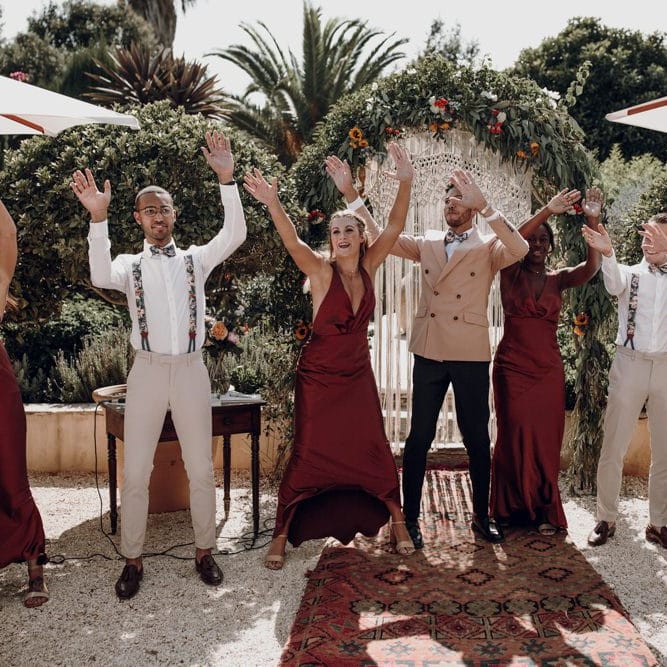 Wedding party waving their arms at the altar