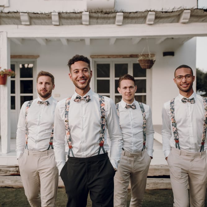 Groomsmen in floral braces and bow ties