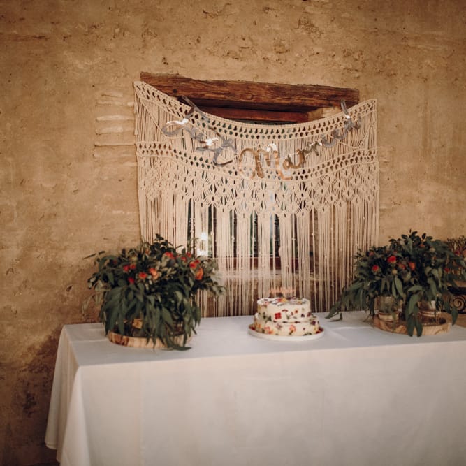 edible flower cake with macrame backdrop