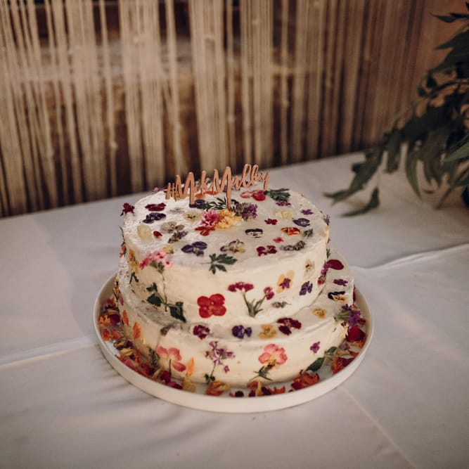 Edible flower cake table with wooden cake topper