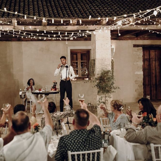 Groom in floral braces and bow tie giving his wedding speech