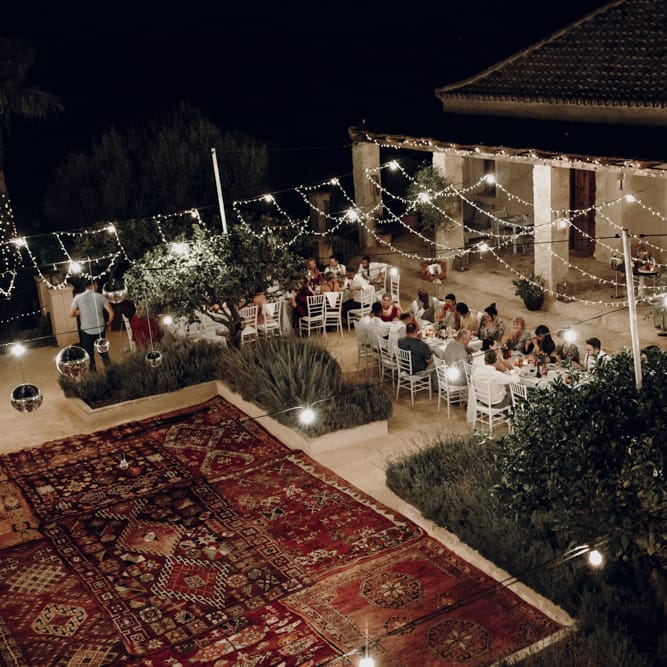 Outdoor wedding reception at Casa la Siesta with rugs and fairy lights decor