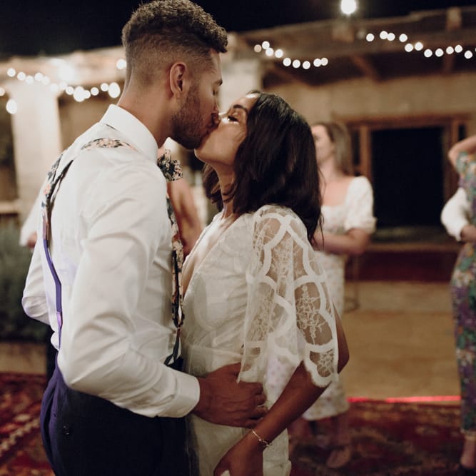 Bride and groom kissing on the dance floor