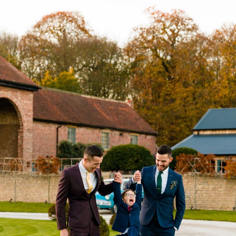 Grooms in Burgundy and Navy Remus Uomo Suits with Page Boy
