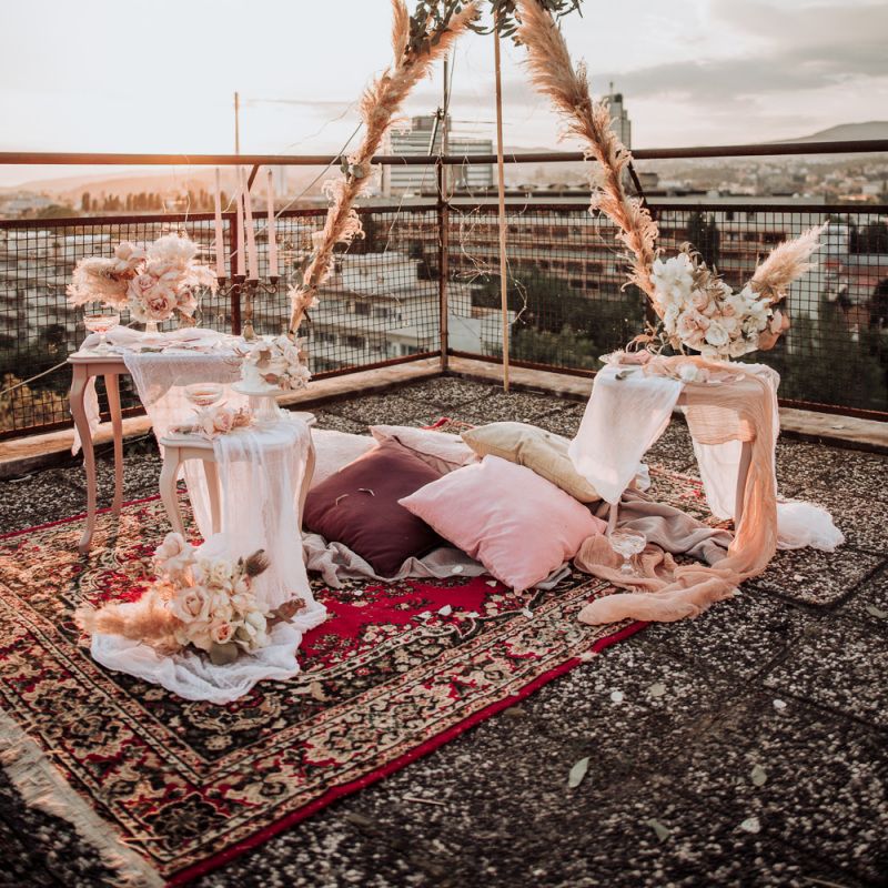 Intimate elopement on a rooftop with boho wedding decor