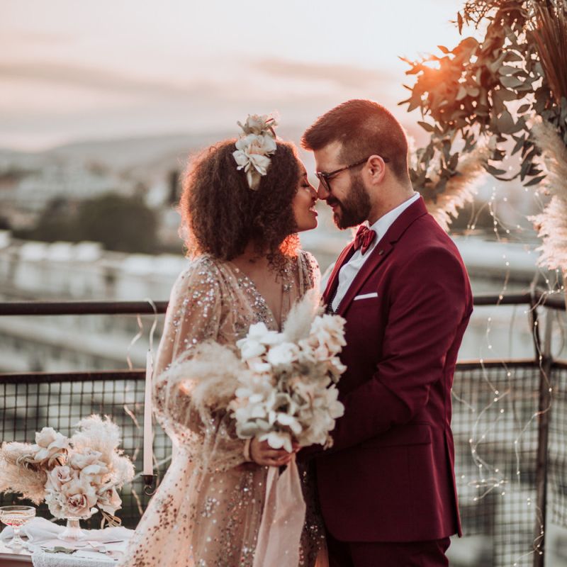 Stylish bride and groom at rooftop wedding ceremony