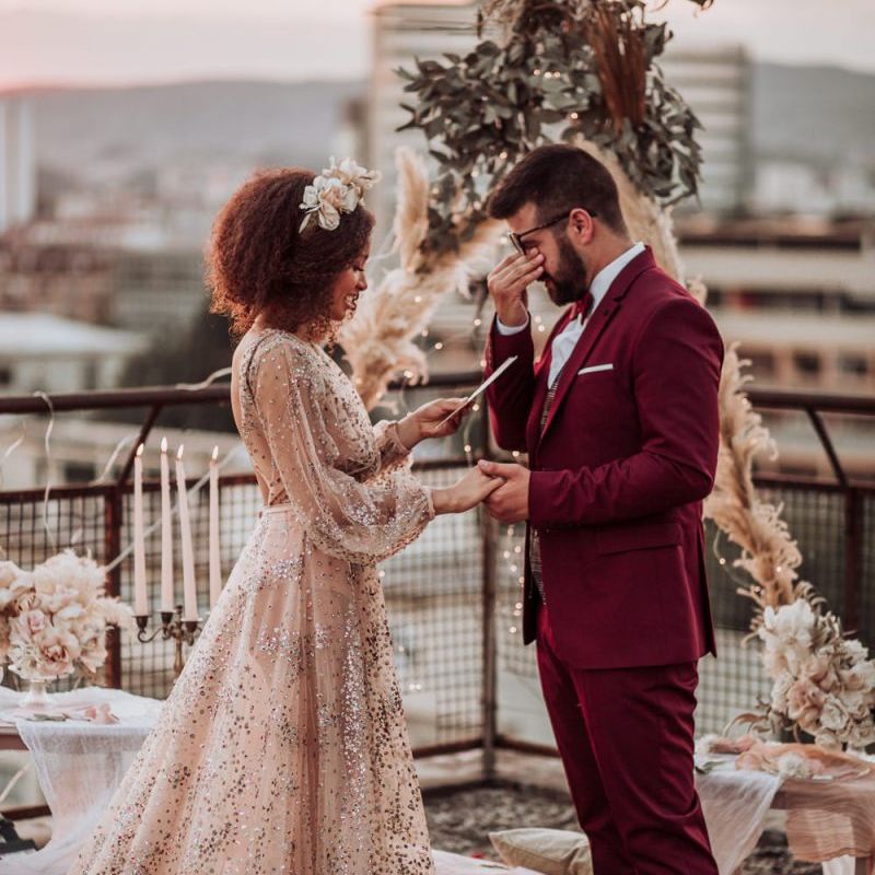 Emotional groom during intimate rooftop wedding ceremony