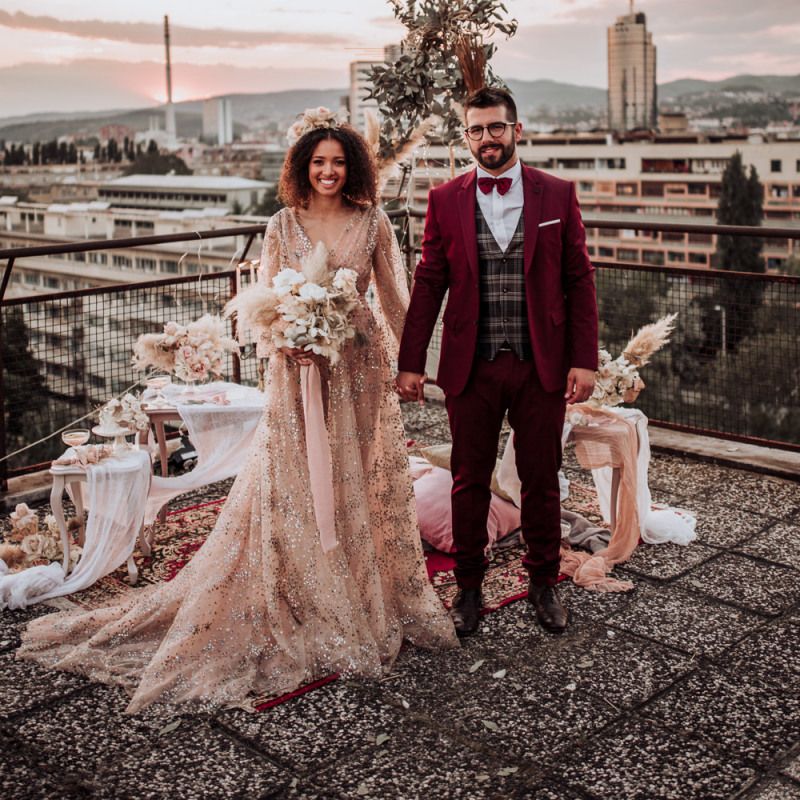 Boho bride and groom at rooftop wedding with sparkle wedding dress
