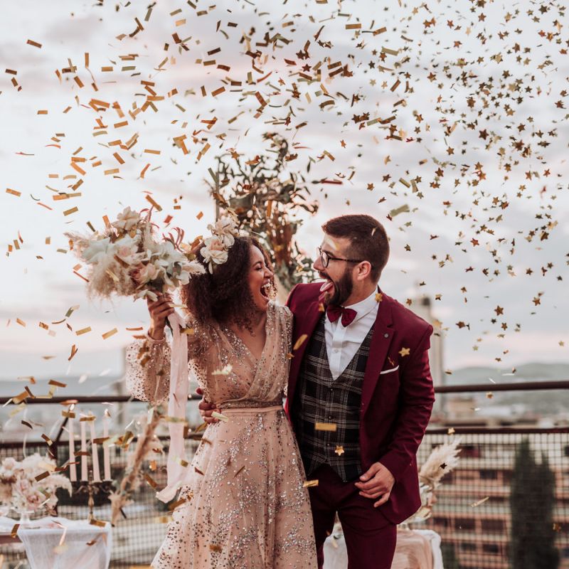 Confetti bomb moment at intimate rooftop wedding with bride in sparkle wedding dress