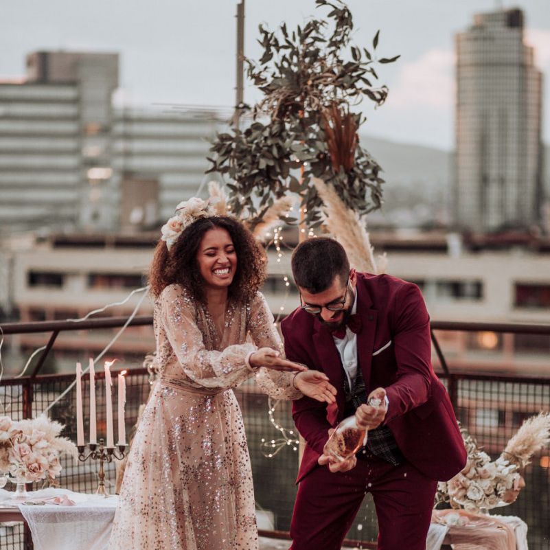 Bride in tulle sparkle wedding dress with curly hair at rooftop wedding