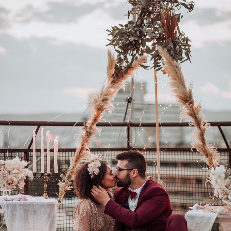 Intimate rooftop wedding with naked tipi, rugs, candles and fairy lights decor