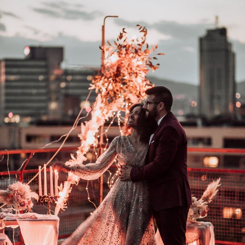 Boho bride in tulle and sparkle wedding dress at rooftop wedding reception