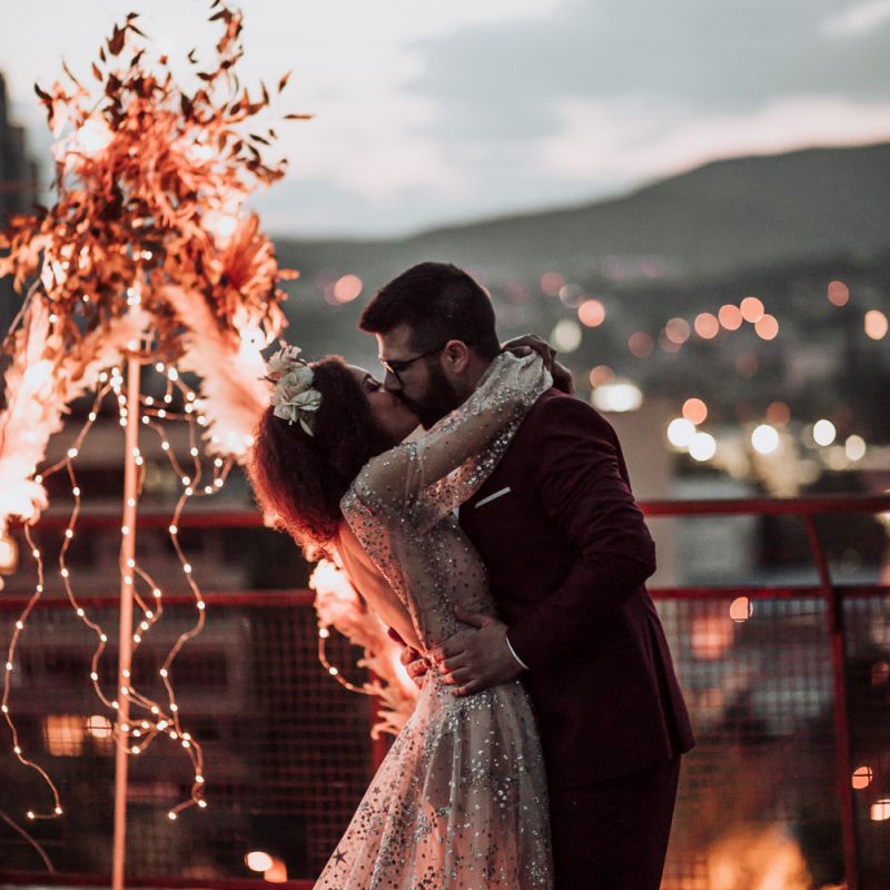 intimate rooftop wedding with bride in sparkle wedding dress glistening  under the fairy lights