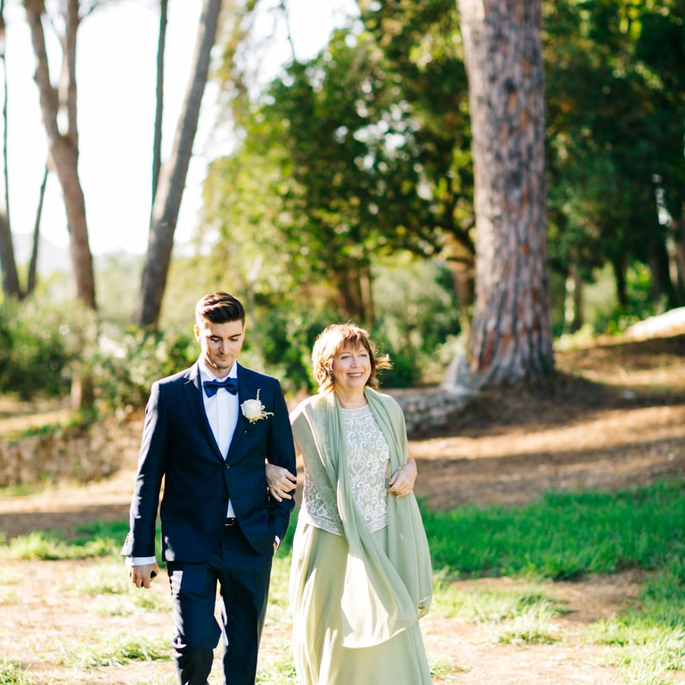 Outdoor Wedding Ceremony | Groom in Black Tie Suit | Pastel Blue &amp; Green, Romantic, Destination Wedding at Corfu Luxury Villas, Planned by Rosmarin Weddings &amp; Events | Mikhail Balygin Fine Art Wedding Photographer