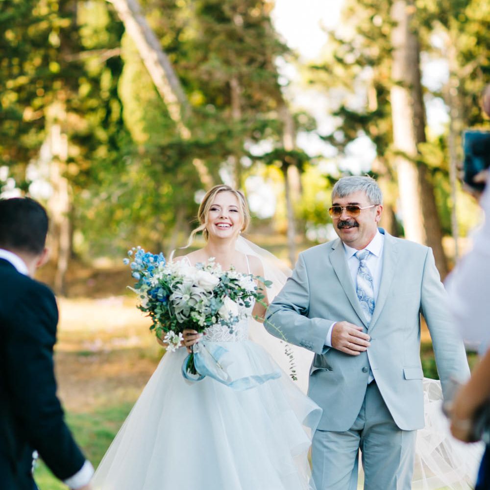 Outdoor Wedding Ceremony | Bridal Entrance in Coloured Hayley Paige Wedding Dress | Father of the Bride in Pale Blue Suit | Pastel Blue &amp; Green, Romantic, Destination Wedding at Corfu Luxury Villas, Planned by Rosmarin Weddings &amp; Events | Mikhail Balygin Fine Art Wedding Photographer