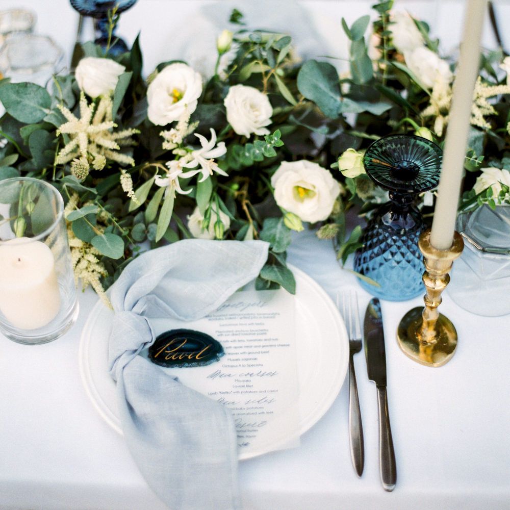 Elegant Place Setting with Coloured Goblet, Floral Table Runner, Taper Candles &amp; Geode Name Place | Pastel Blue &amp; Green, Romantic, Destination Wedding at Corfu Luxury Villas, Planned by Rosmarin Weddings &amp; Events | Mikhail Balygin Fine Art Wedding Photographer