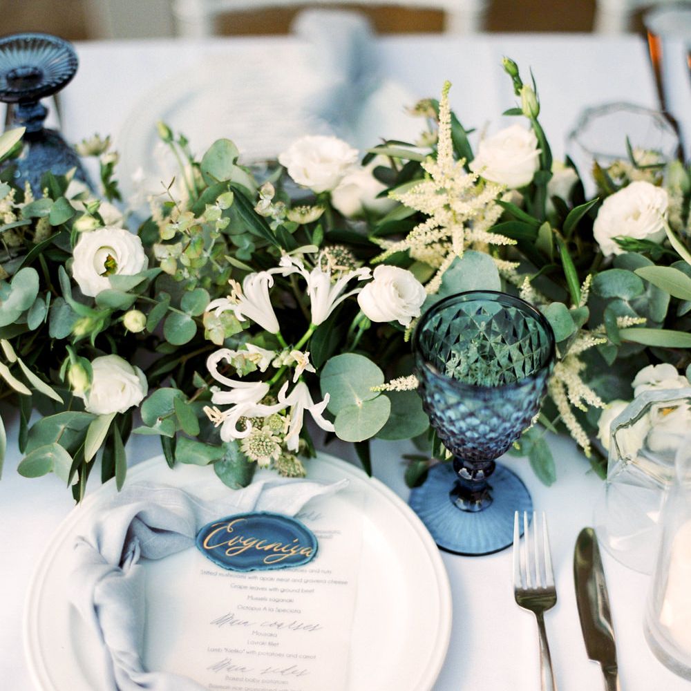 Elegant Place Setting with Coloured Goblet, Floral Table Runner, Taper Candles &amp; Geode Name Place | Pastel Blue &amp; Green, Romantic, Destination Wedding at Corfu Luxury Villas, Planned by Rosmarin Weddings &amp; Events | Mikhail Balygin Fine Art Wedding Photographer