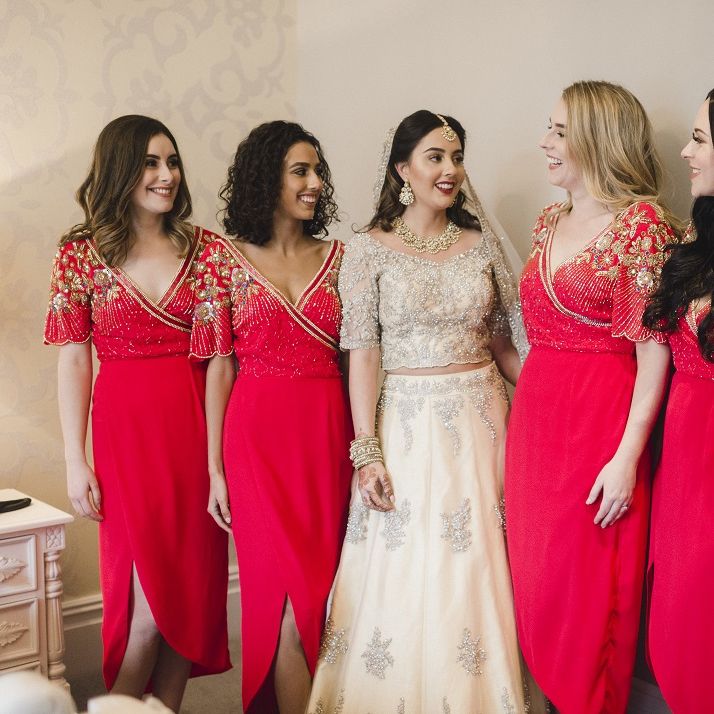 Bride with bridal party in red bridesmaid dresses