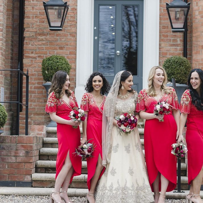 Red bridesmaid dresses with bright flower bouquets