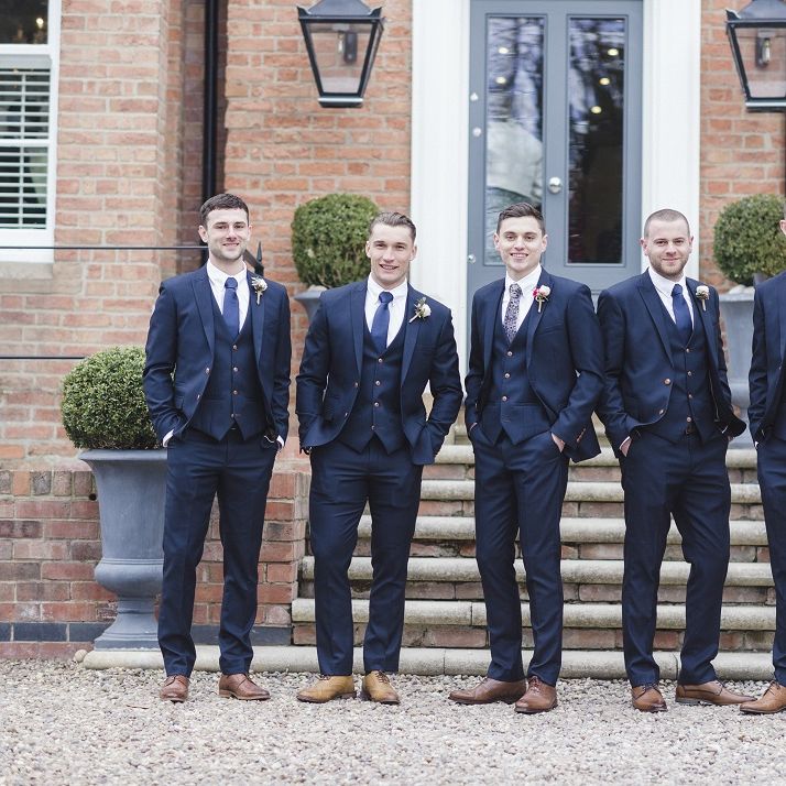 Groom and groomsmen in blue wedding suits