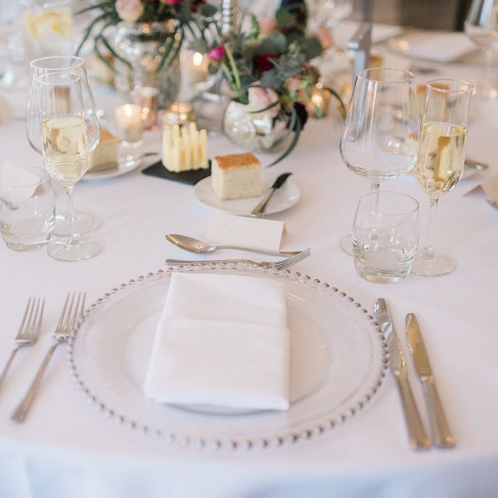 Wedding table decor at fusion wedding with red bridesmaid dresses