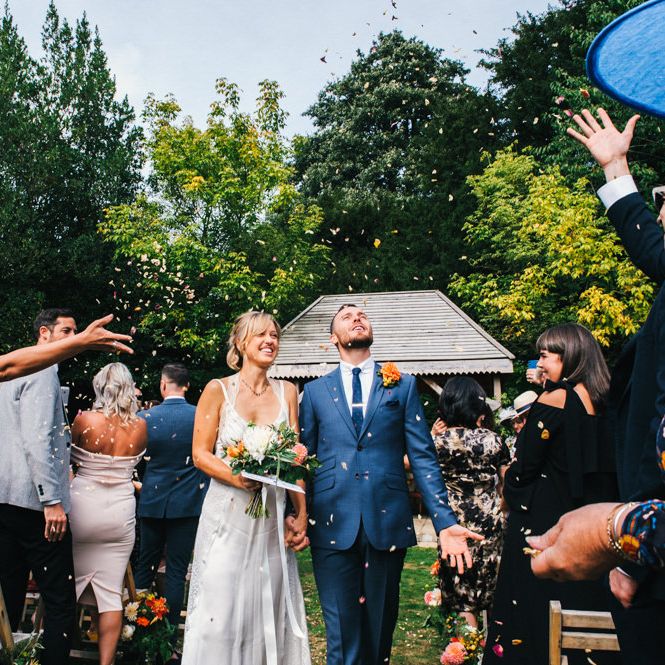 Confetti Moment | Bride in Racerback Alexander Wang Wedding Dress | Groom in Blue Ted Baker Suit | Colourful Pennard House Wedding | Allison Dewey Photography
