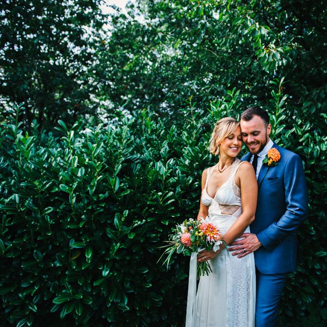 Bride in Racerback Alexander Wang Wedding Dress | Groom in Blue Ted Baker Suit | Bright Bouquet of Dahlias with Trailing Ribbon | Colourful Pennard House Wedding With Bride Wearing Racerback Dress | Allison Dewey Photography